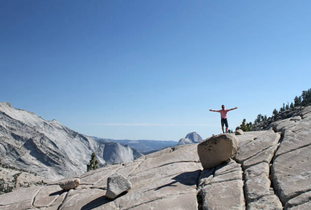 istock Young man with raised arms in Yosemite 1160963155