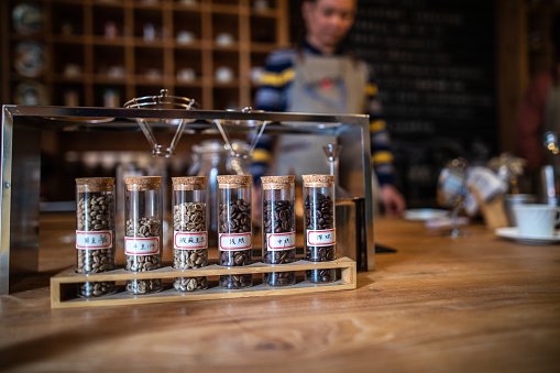 Close up of Different types of coffee in glass jars in coffee shop