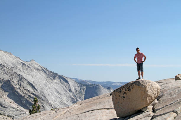 istock Young man standing on a rock in Yosemite 1160963299