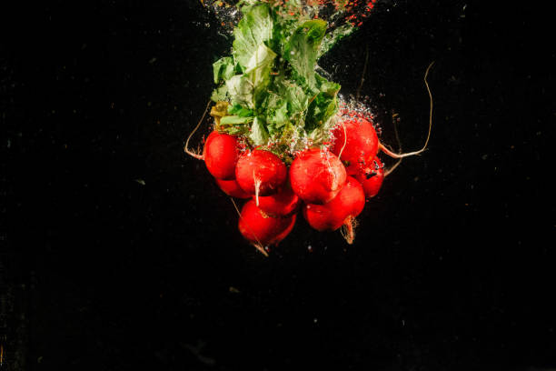 istock Bunch of red redish falls on black background 1160963319