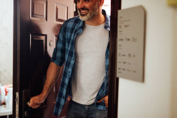 istock Mid-adult man entering office 1160963639