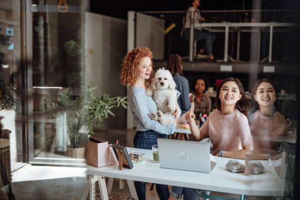 istock Young coworkers playing with dog during lunch break 1160963723