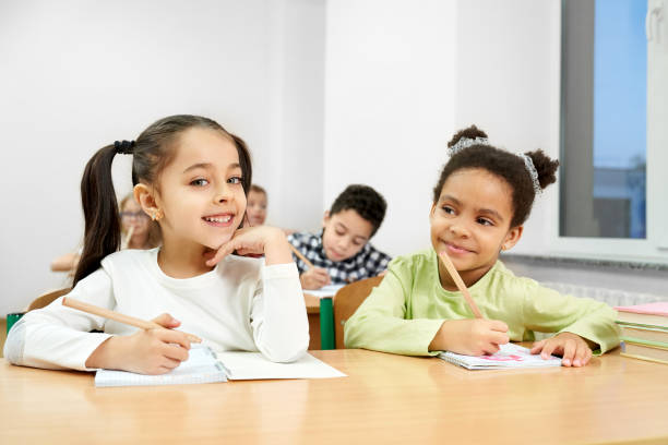 istock Beautiful girls posing in classroom while studying at school 1160964767