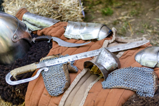 istock A medieval knights equipment, sword and iron protective gloves on desk 1160965525
