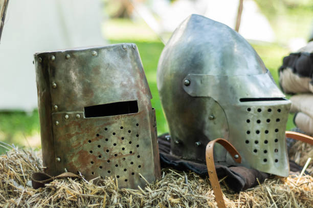 istock Knightly medieval metal two helmets on the stand 1160966155