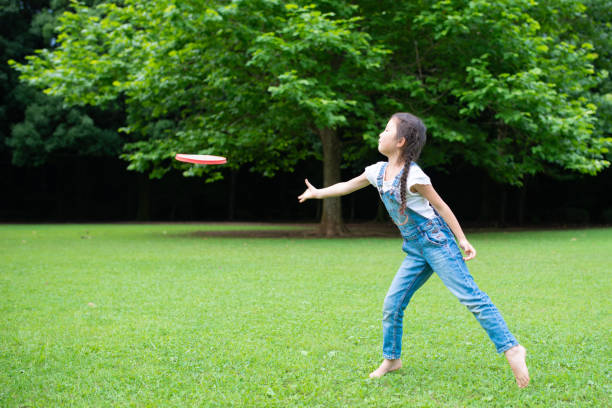 istock Girl playing with frisbee 1160966501