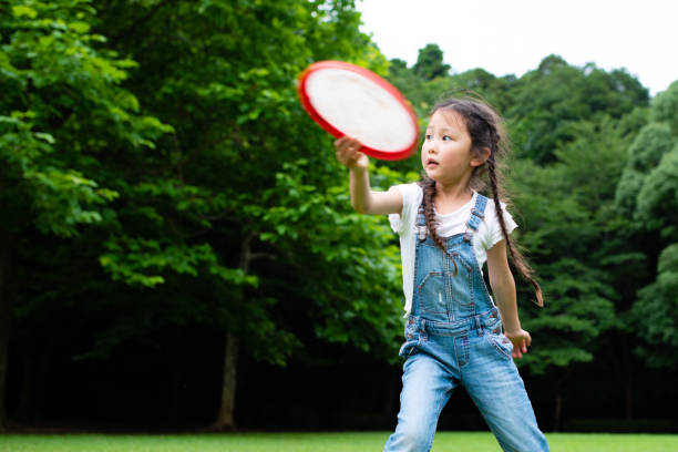 istock Girl playing with frisbee 1160966561