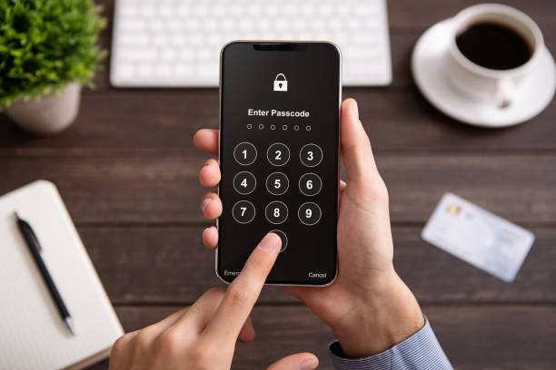 istock Man holding modern mobile smartphone with login form 1160967859