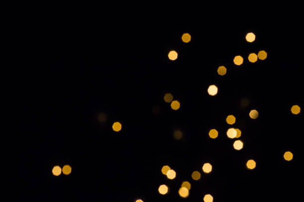 istock Black festive background. Gold hexagonal bokeh lights fall and shine 1160968176