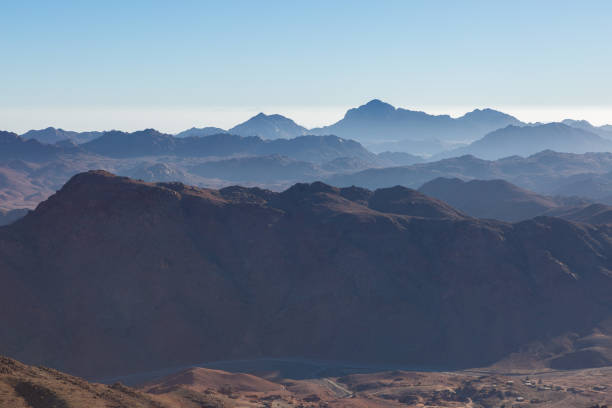 istock Beautiful view from the mountain. Panorama. Mountain range with visible silhouettes through the morning blue fog 1160969255