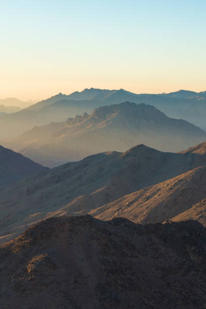 istock Beautiful view from the mountain. Panorama. Mountain range with visible silhouettes through the morning blue fog 1160969318