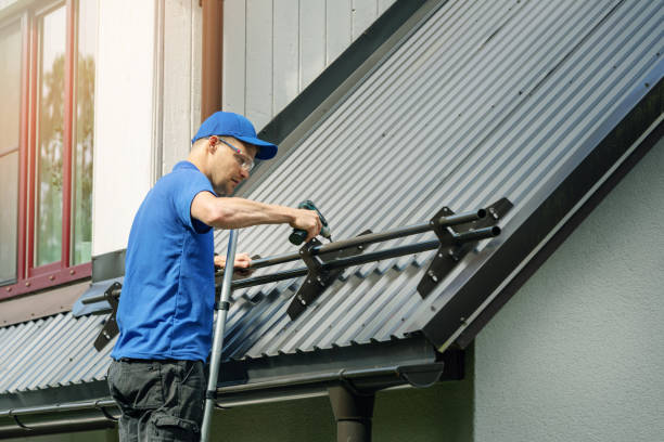 istock roofer installing snow guard on metal roof 1160969501