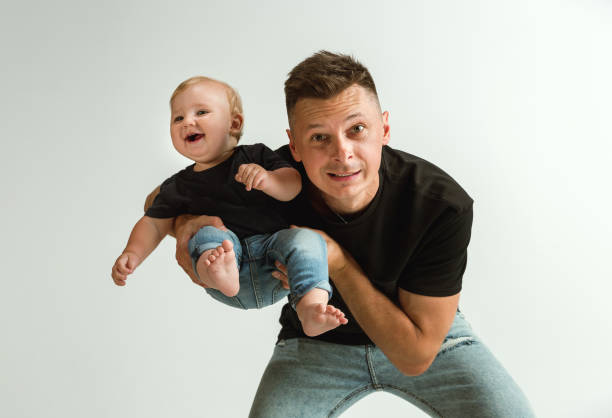 istock Happy father holding adorable little son and smiling 1160969522
