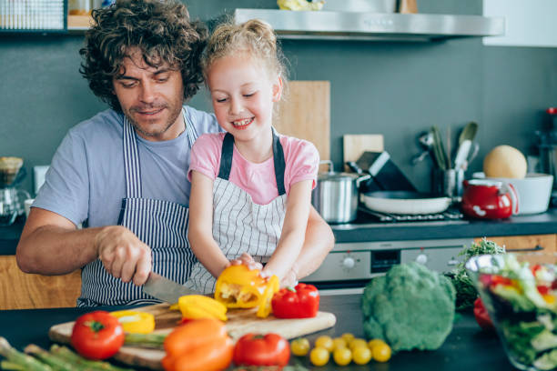 istock Happy father and his daughter having fun at kitchen 1160970368
