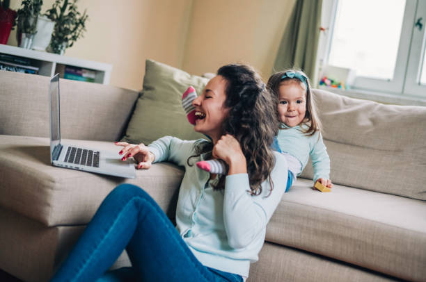 istock Mother and daughter using laptop on sofa 1160970390