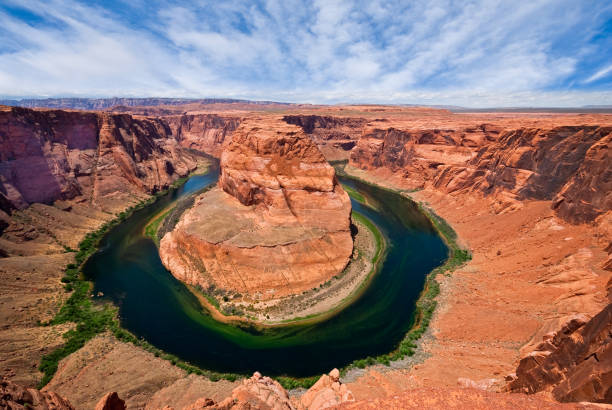 Horseshoe Bend on the Colorado River The Colorado River provides some incredible natural vistas along its length.  One of the more unusual views is at Horseshoe Bend.  The name was inspired by its unusual shape, a horseshoe-shaped meander of the river.  Horseshoe Bend, located about four miles southwest of Page, Arizona, USA within the Glen Canyon National Recreation Area has become a very popular tourist attraction. jeff goulden mojave desert stock pictures, royalty-free photos & images