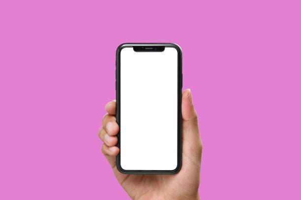 istock Hand holding the black smartphone with blank screen and modern frame less design on pink colour background 1160972993