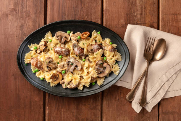 istock Mushroom and cheese pasta with green peas, top shot 1160975344