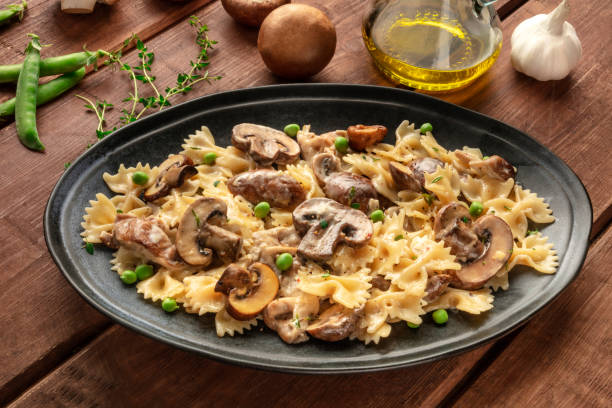 istock Mushroom pasta with ingredients on a dark rustic wooden background 1160975348