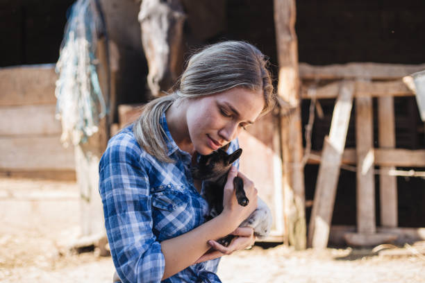 istock Affectionate girl holding a sleepy small goat 1160975412