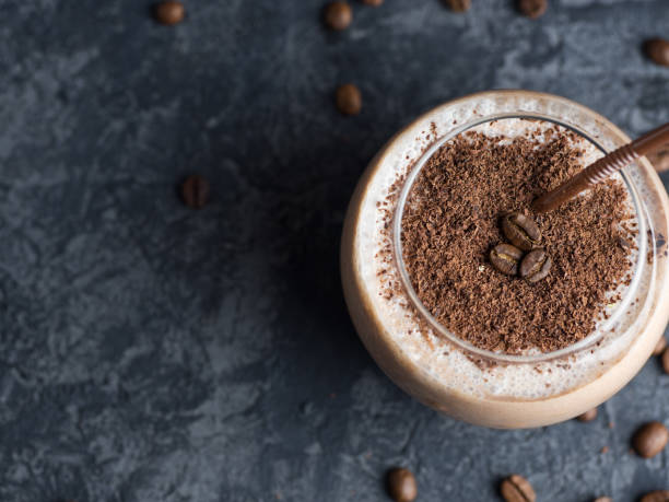 istock Chocolate coffee smoothie in a glass on a concrete table with copyspace 1160975526