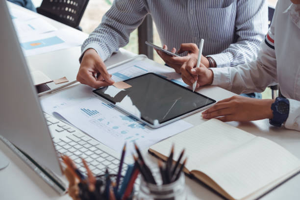 istock Cropped shot of startup UX UI front end designers drawing responsive web content or mobile app with graphics tablet.UX team designers sketching prototype and wireframe layout. 1160975706