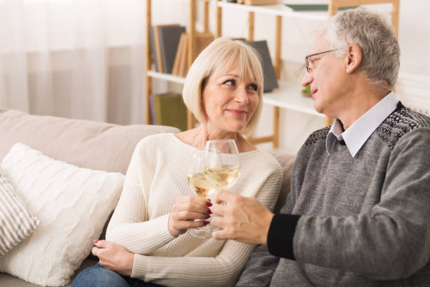 istock Senior couple clinking wine glasses and looking at each other 1160976630