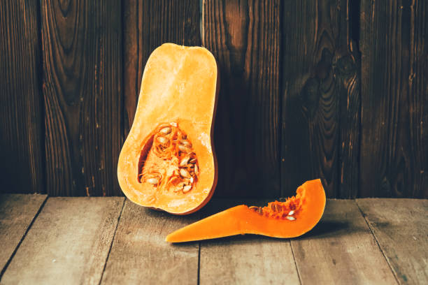 istock wooden table with cutaway fresh squash 1160977047