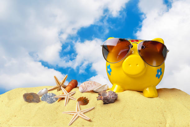 istock Piggy bank on beach vacation 1160978225