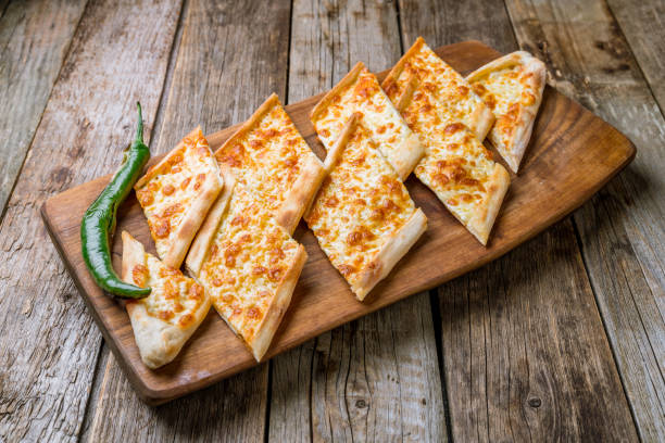 istock Turkish pide with cheese on wooden background 1160978339