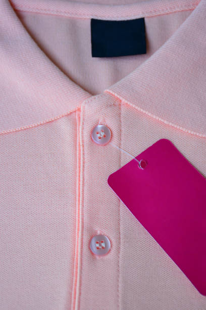 istock Light orange polo t-shirt and pink tag label. 1160979325