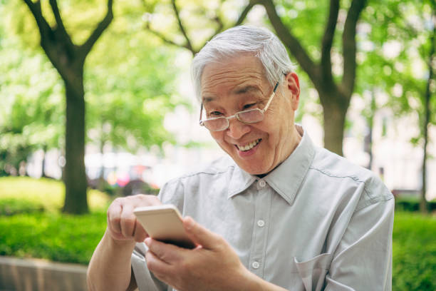 istock Tech-Savvy Senior Chinese Man Communicating on Smart Phone 1160979644