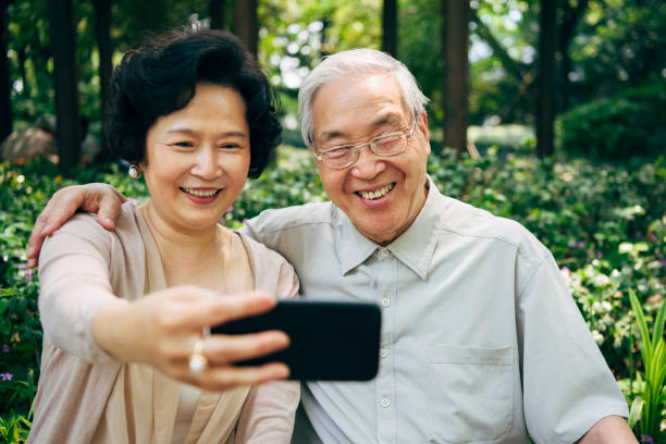 istock Relaxed Chinese Seniors Creating Smiling Selfie at the Park 1160979658
