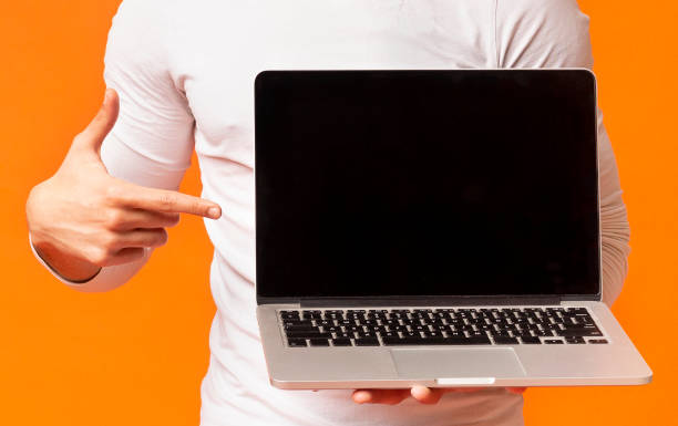 istock Black guy pointing finger on blank laptop screen 1160982668