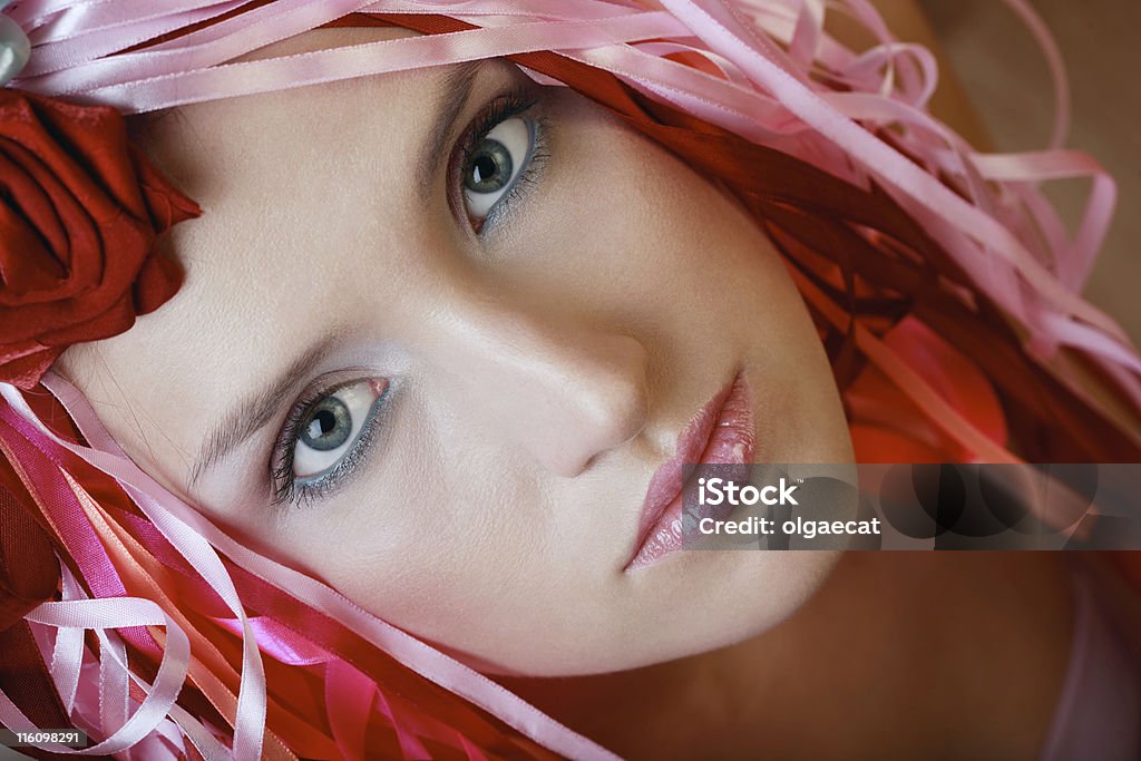 Pink fantasy Close-up portrait of beautiful blue-eyed girl with professional makeup and colorful silky ribbons on her head Adolescence Stock Photo