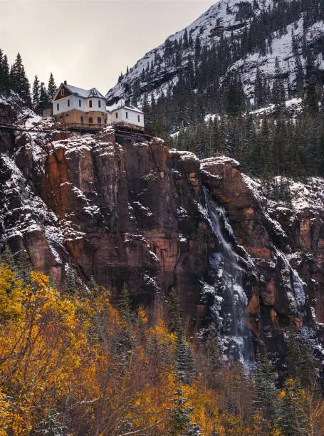 Photo of Bridal Veil Falls with a power plant at its top in Telluride, Colorado