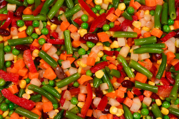 istock Sliced vegetables, corn, beans, peas, carrots, sweet peppers background. 1160983757