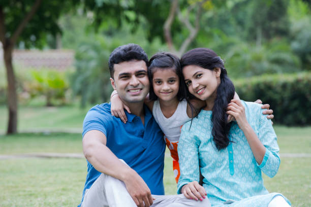 India Family in park - stock images Indian, Family, weekend, real people, bonding happy indian young family couple stock pictures, royalty-free photos & images