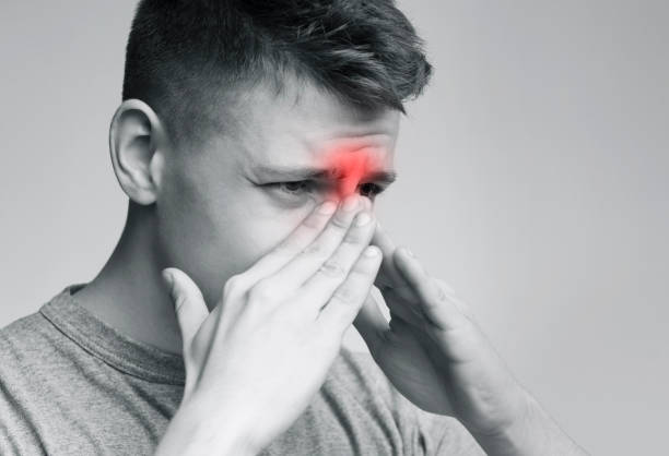 istock Sad man holding his nose because sinus pain 1160986575