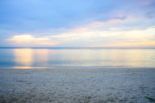 istock Landscape of sandy beach with soft wave and sunrise sky with cloud 1160991691
