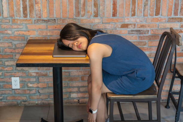istock Overworked female millennial fall asleep on laptop at wooden table 1160992973