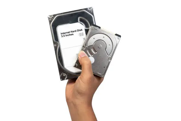 Hard disk Internal SATA and ATA 3.5 and 2.5 inches holding on technician man isolated on white background. Hand and computer hard disk drive technology.