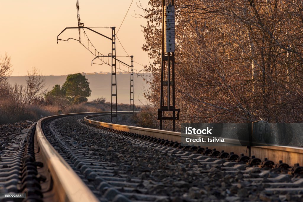 Unique railroad line at the sunset. Train railway track . Low clouds over the railroad. Unique railroad line at the sunset. Train railway track. Low clouds over the railroad. Train - Vehicle Stock Photo