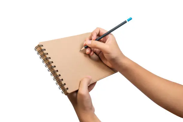 Close up of open brown blank notebook with ring loop binding. Empty wire-o brown notebook holding hand and pencil for business and education for write and note.