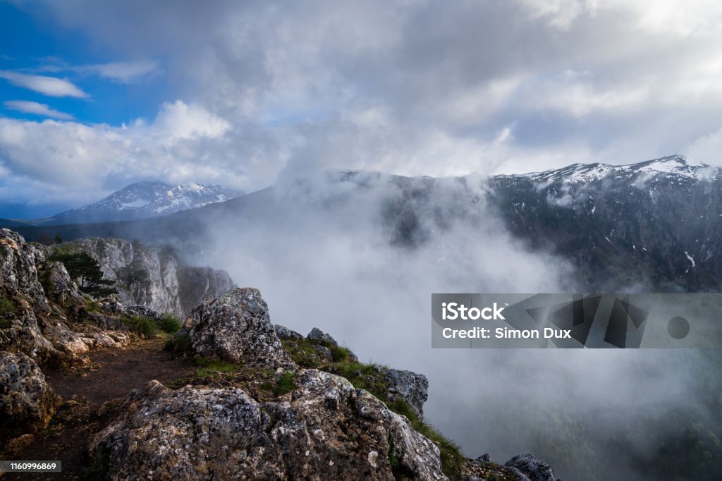 Montenegro, Misty atmosphere and extremely fast changing weather on summit of mount curevac at the edge of tara river canyon inside durmitor national park nature landscape near zabljak Alpine climate Stock Photo