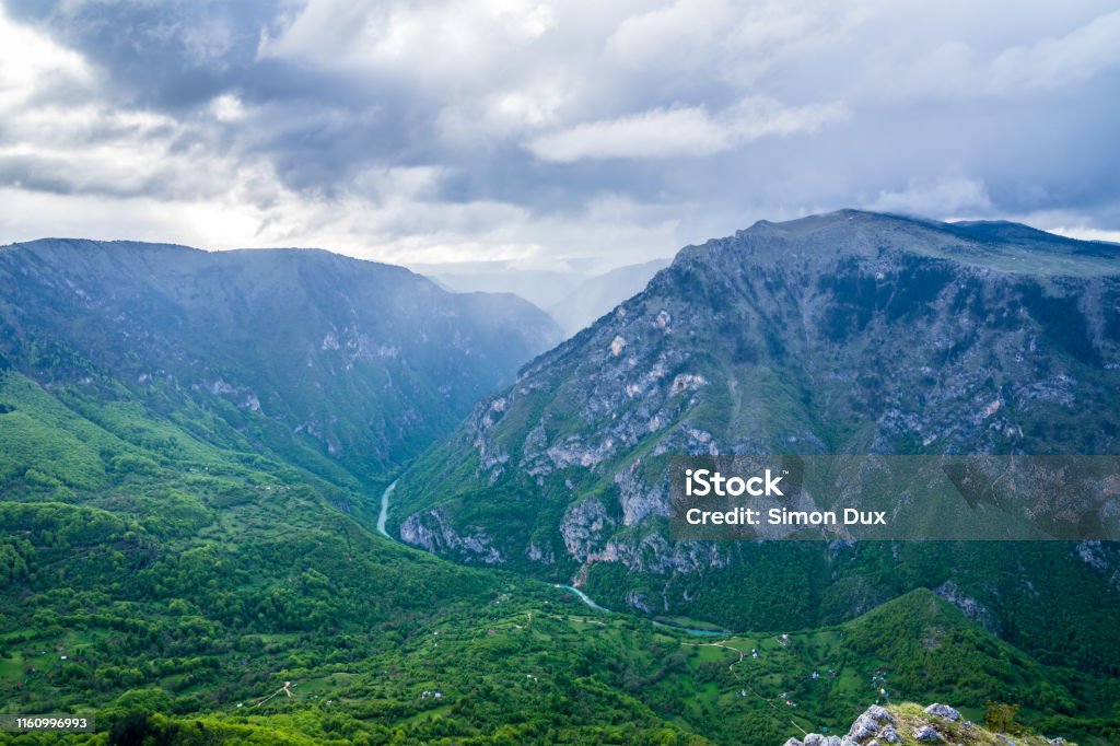 Montenegro, Above green forested nature landscape of spectacular tara river canyon from peak of mountain curevac at dawn after rain in durmitor national park near zabljak Above Stock Photo
