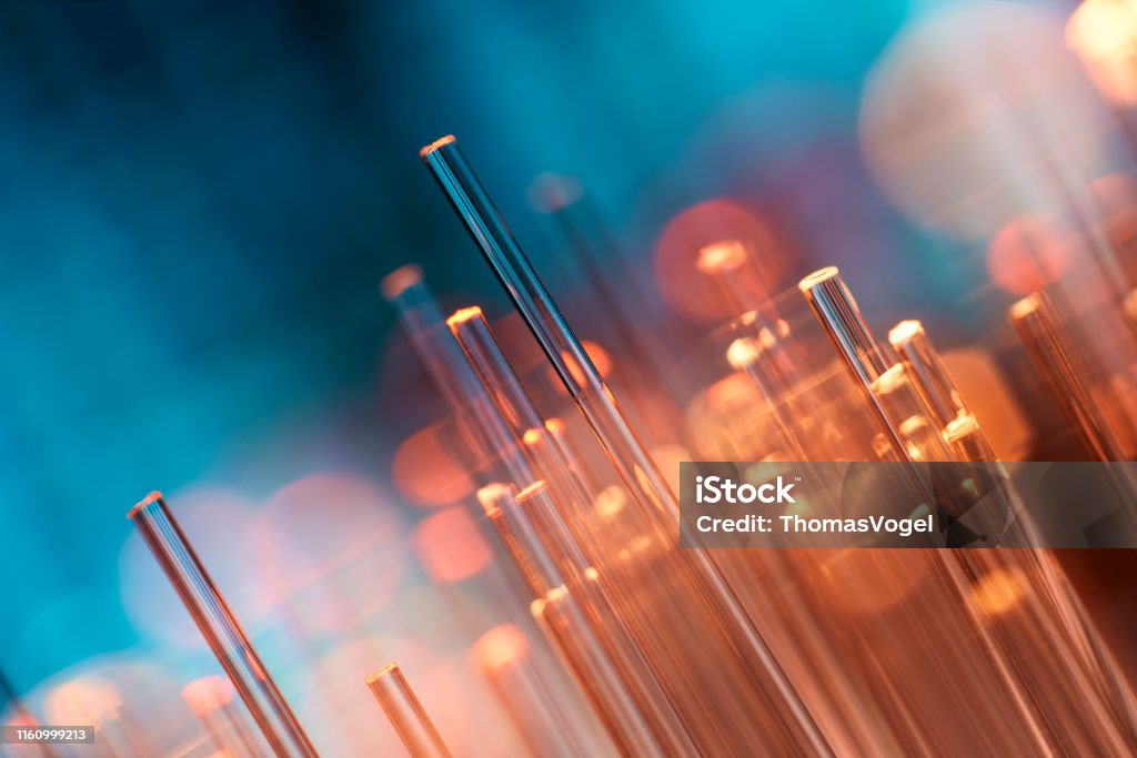 Fiber optics abstract background - Blue Data Internet Technology Cable Close up of fiber optic cables. Fiber Optic Stock Photo