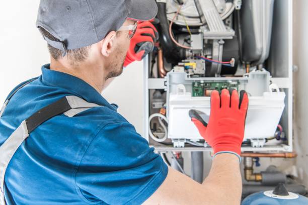 Heating Central Gas Furnace Heating Central Gas Furnace Issue. Technician Trying To Fix the Problem with the Residential Heating Equipment. furnace stock pictures, royalty-free photos & images