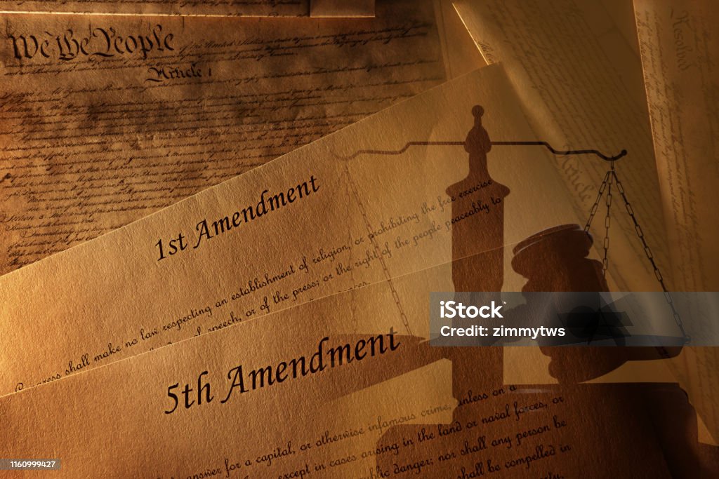 US Constitution and amendments with gavel The First and Fifth Amendments and pages of the US Constitution with legal gavel and scales of justice Constitution Stock Photo