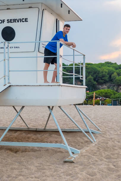 istock Cool young man on the rescue cabin at a Mediterranean beach 1160999689